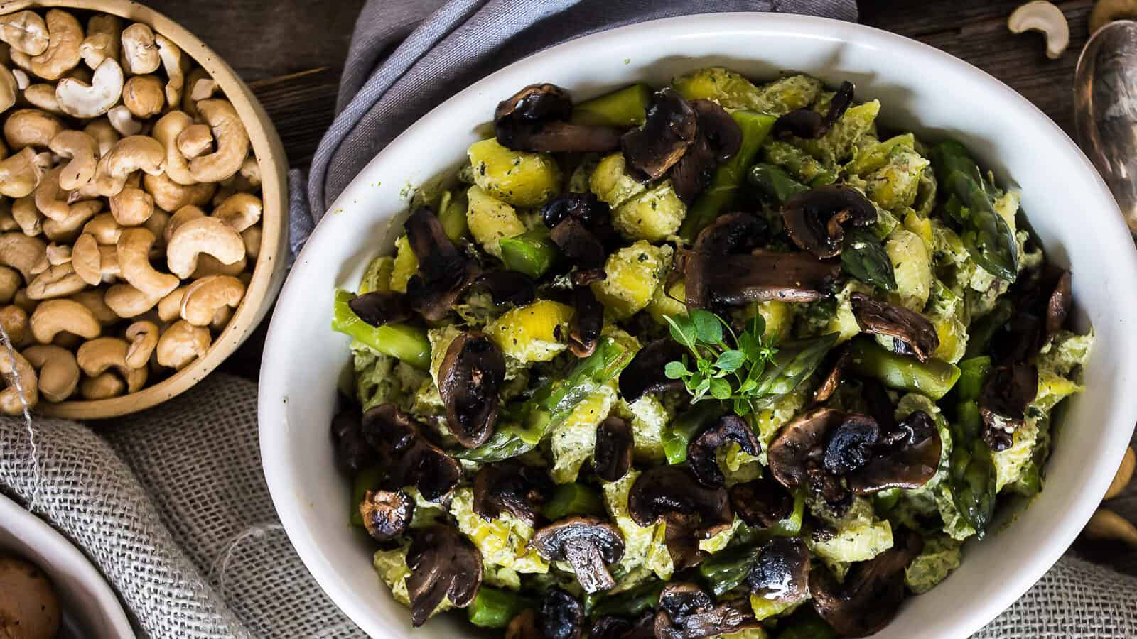 Overhead of pasta with mushrooms and green goddess sauce.