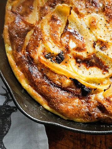 A close-up of a rutabaga rosti in a cast iron skillet.