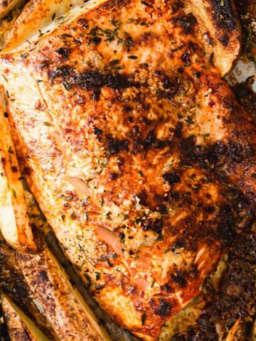 Grilled salmon and potatoes on a baking sheet.