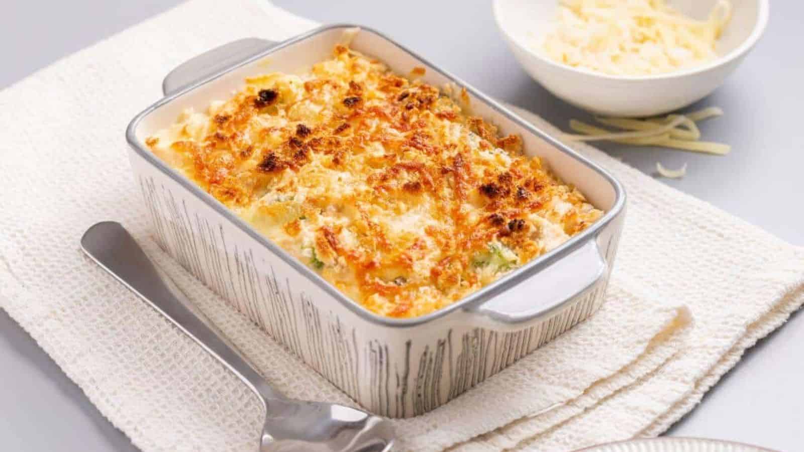 A casserole dish with cheese and broccoli on a napkin.