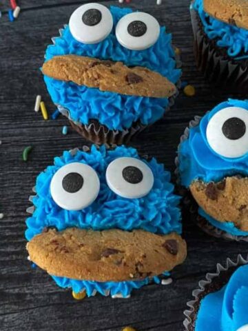 Cookie monster cupcakes with white and black eyes.