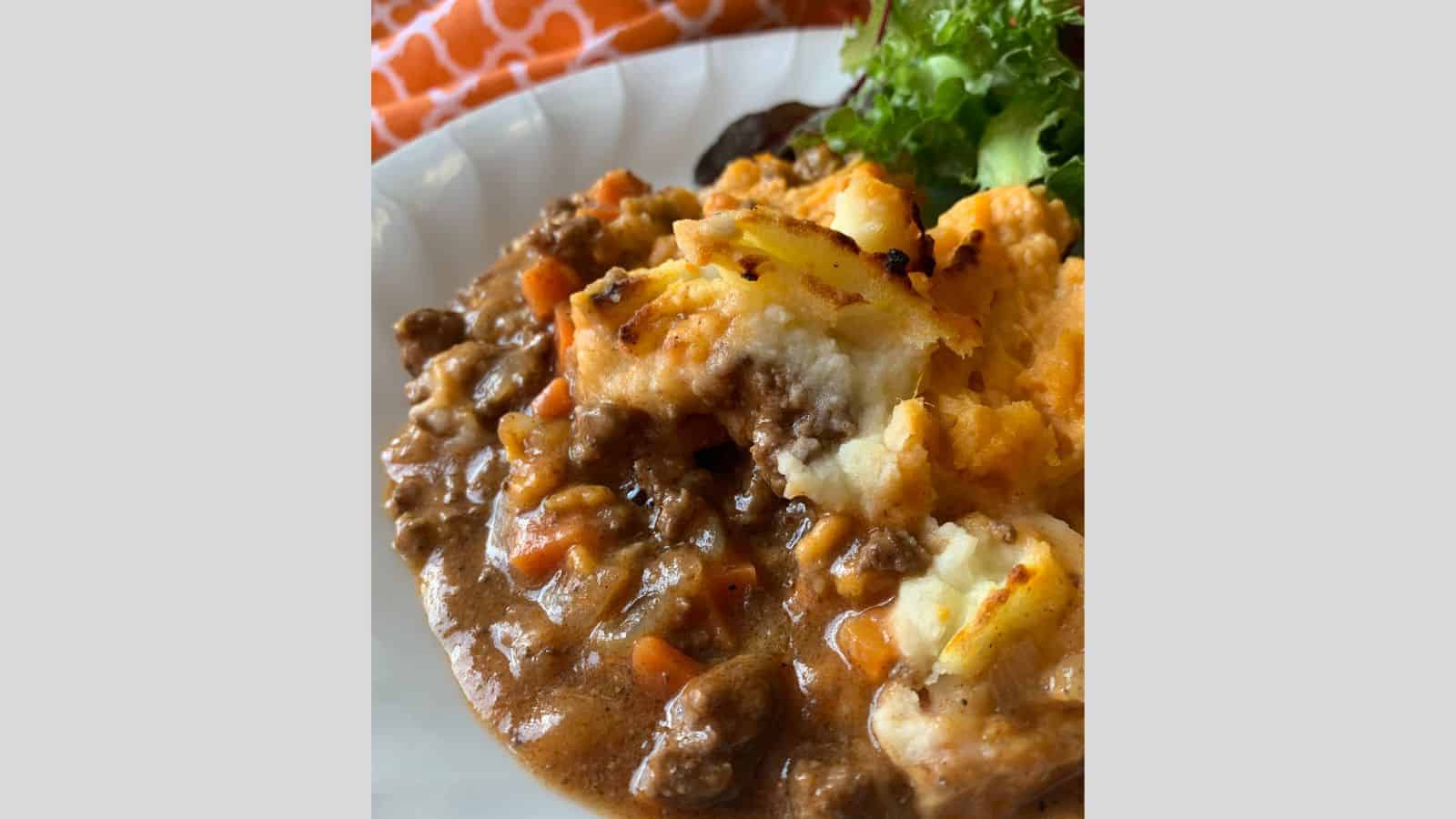 Hot ground beef gravy and vegetables cottage pie beneath a mashed potato crust.
