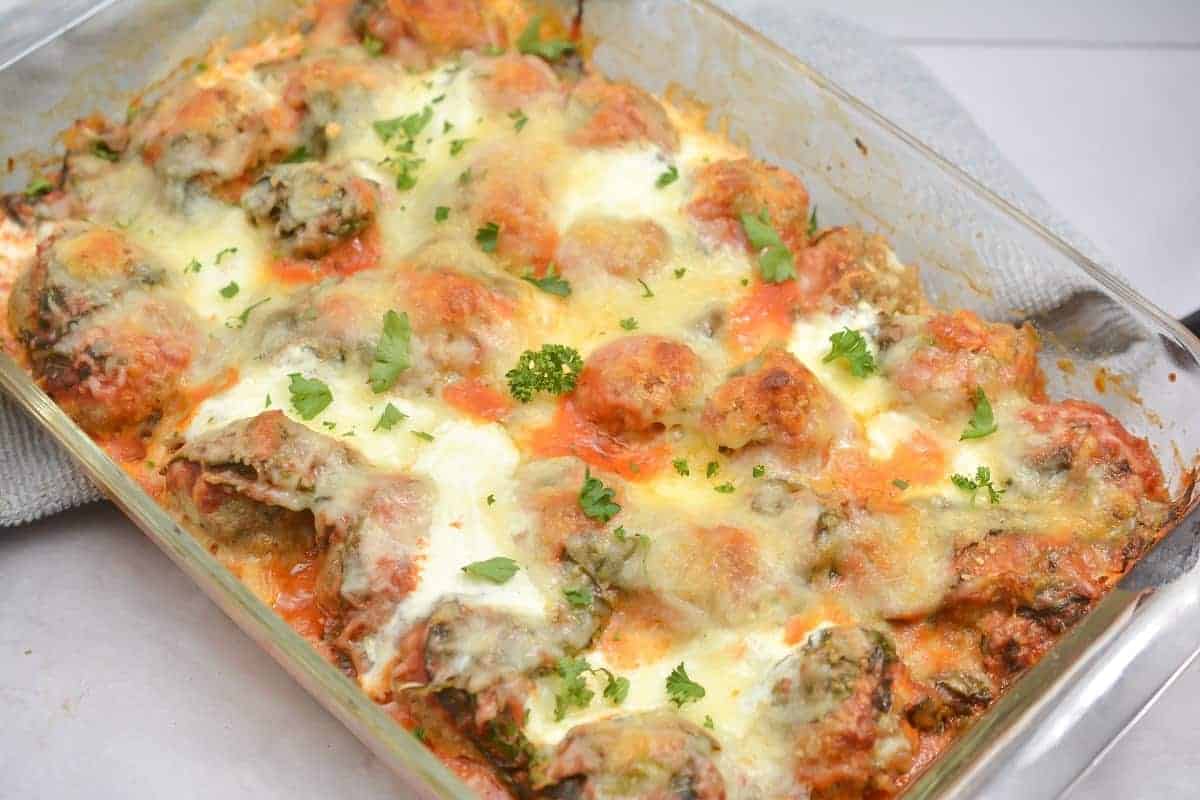 Meatball casserole on a white tray.
