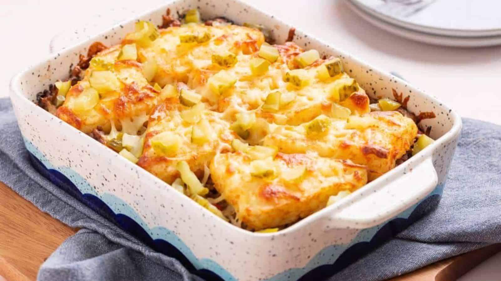 Cheesy hashbrown topped casserole in baking pan.