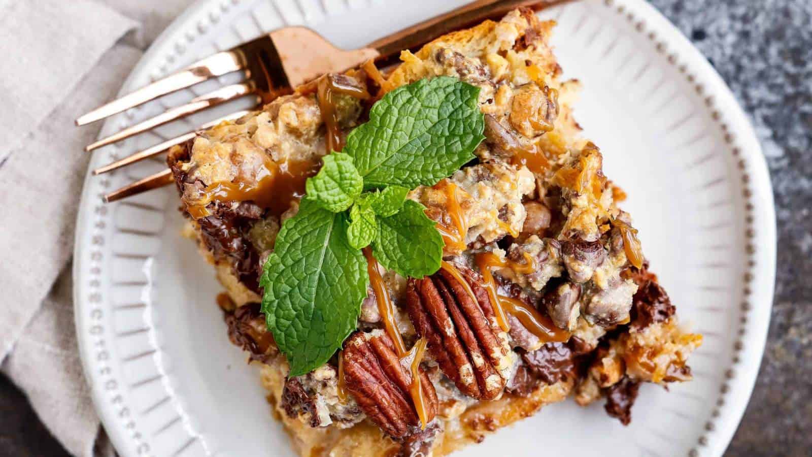 Flat lay of bread pudding topped with pecans and mint for garnish.
