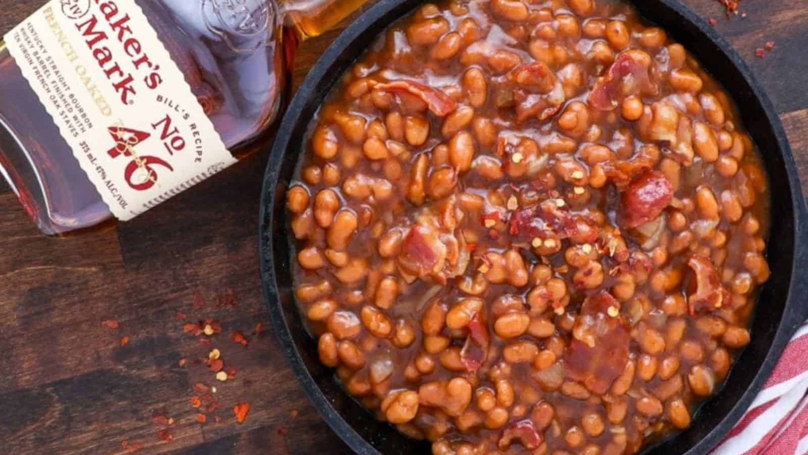 A bowl of bourbon baked beans with a rich, thick sauce.