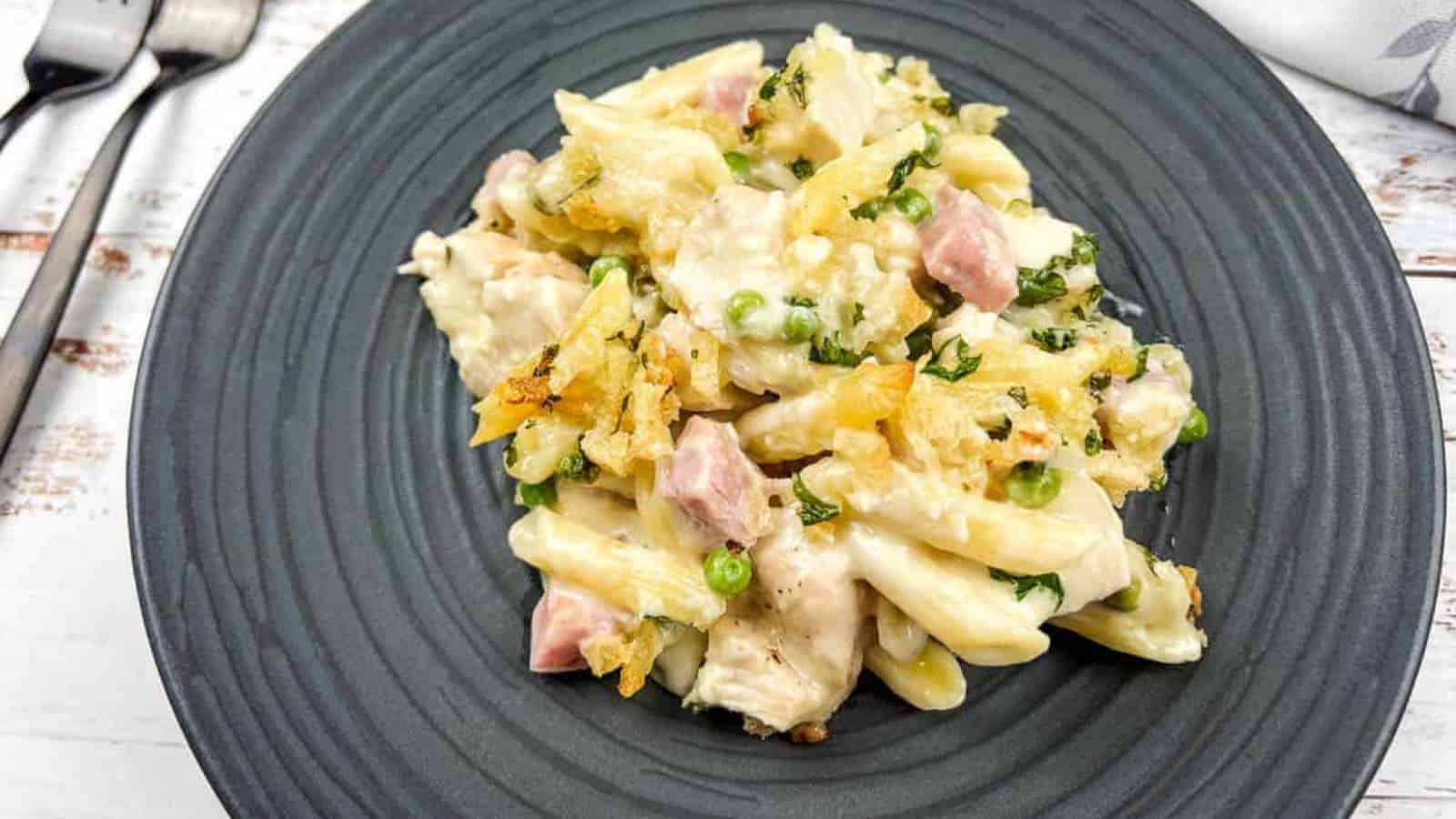 Chicken cordon bleu casserole on a black plate with a fork.