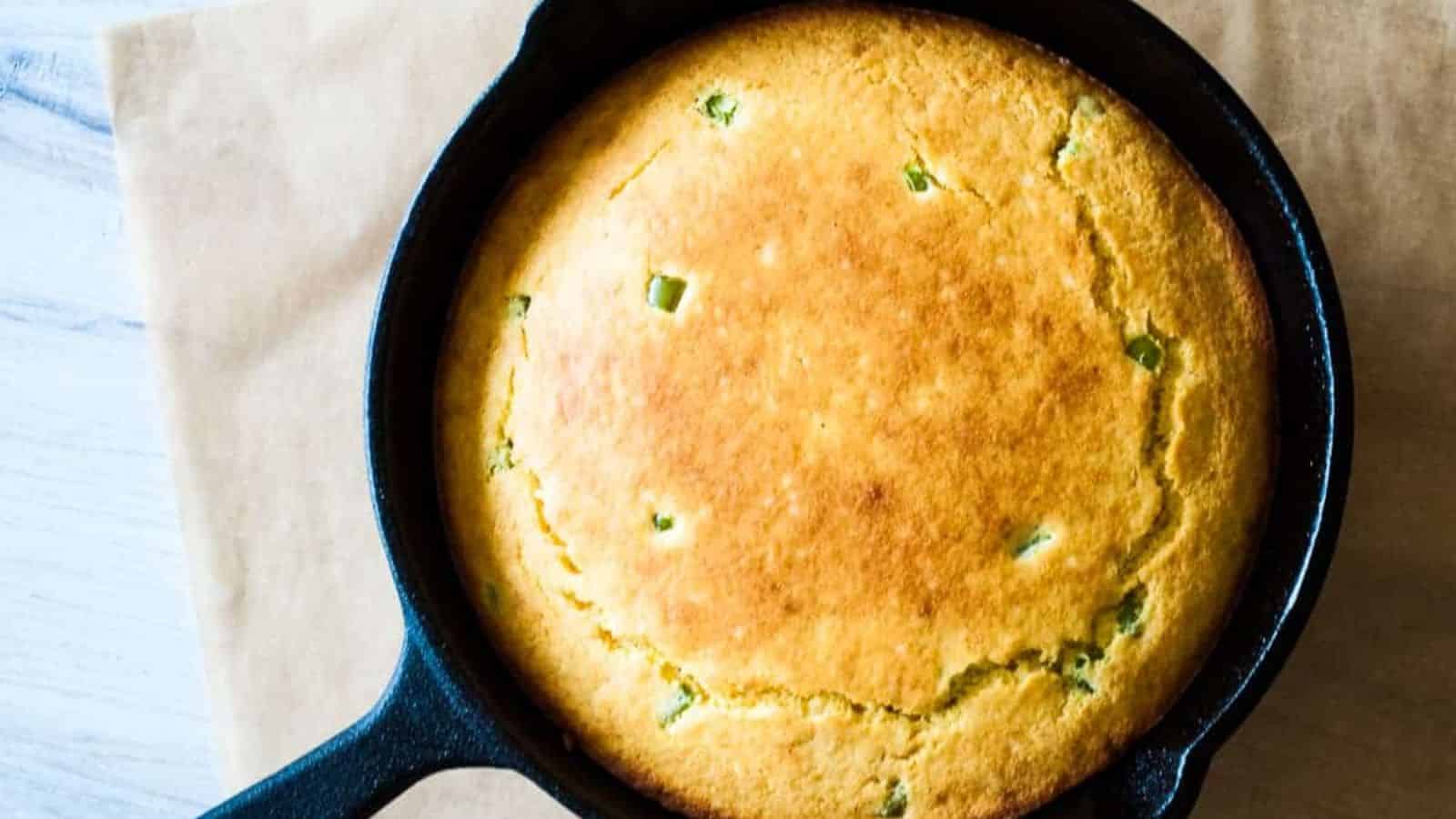 A cast irons skillet with jalape&ntilde;o corn bread in it.