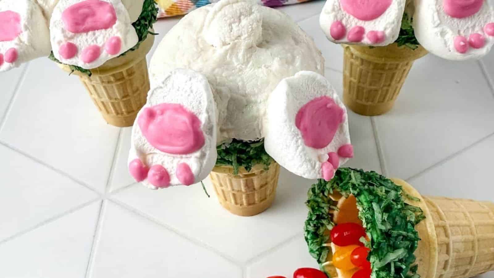 Image of 3  bunny butt cupcakes with jelly beans on counter.