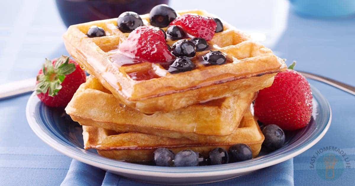 Easy waffle recipe with no milk stack on blue plate.