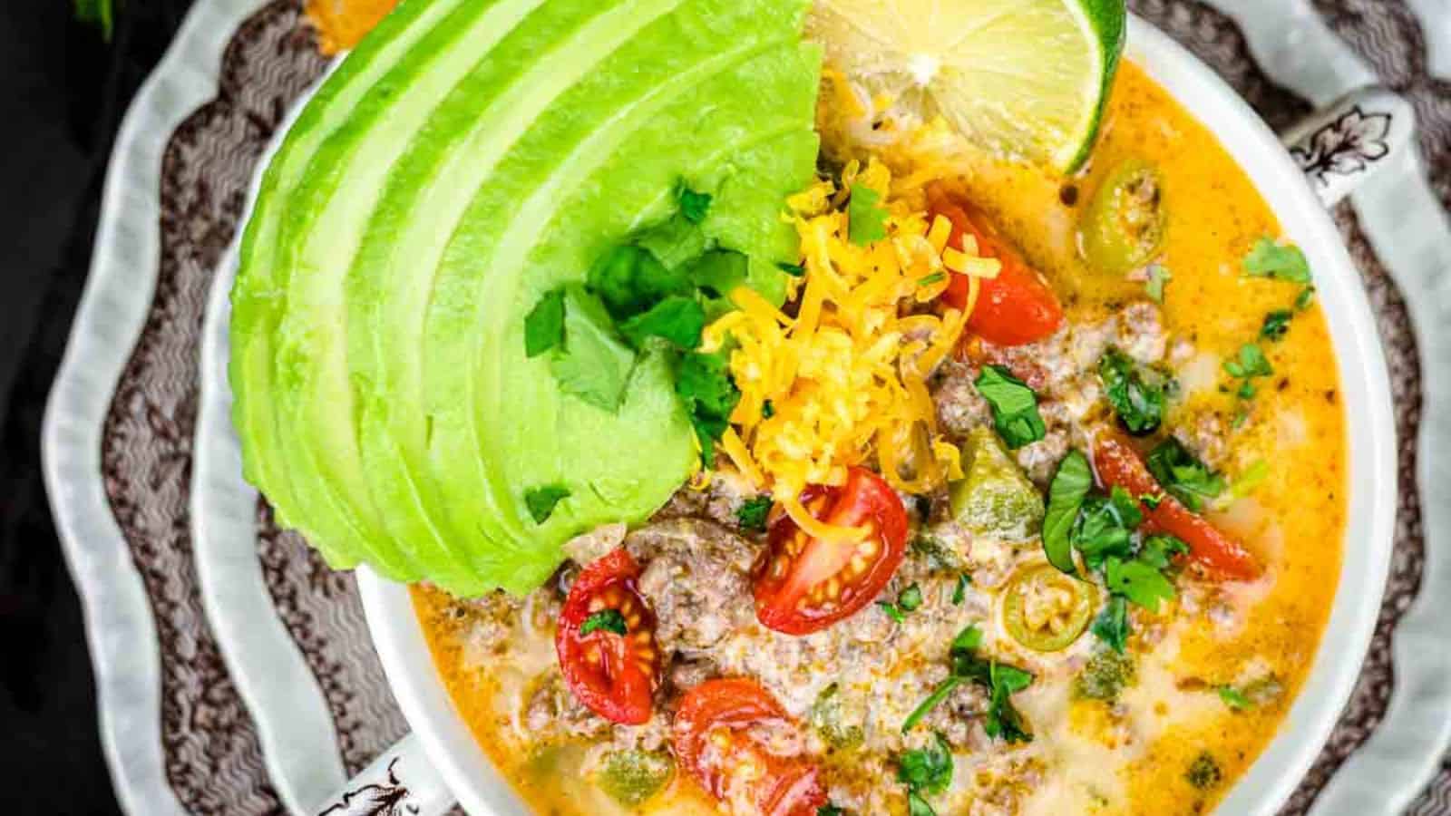 Creamy Keto Taco Soup with gresh avocado slices and lime.