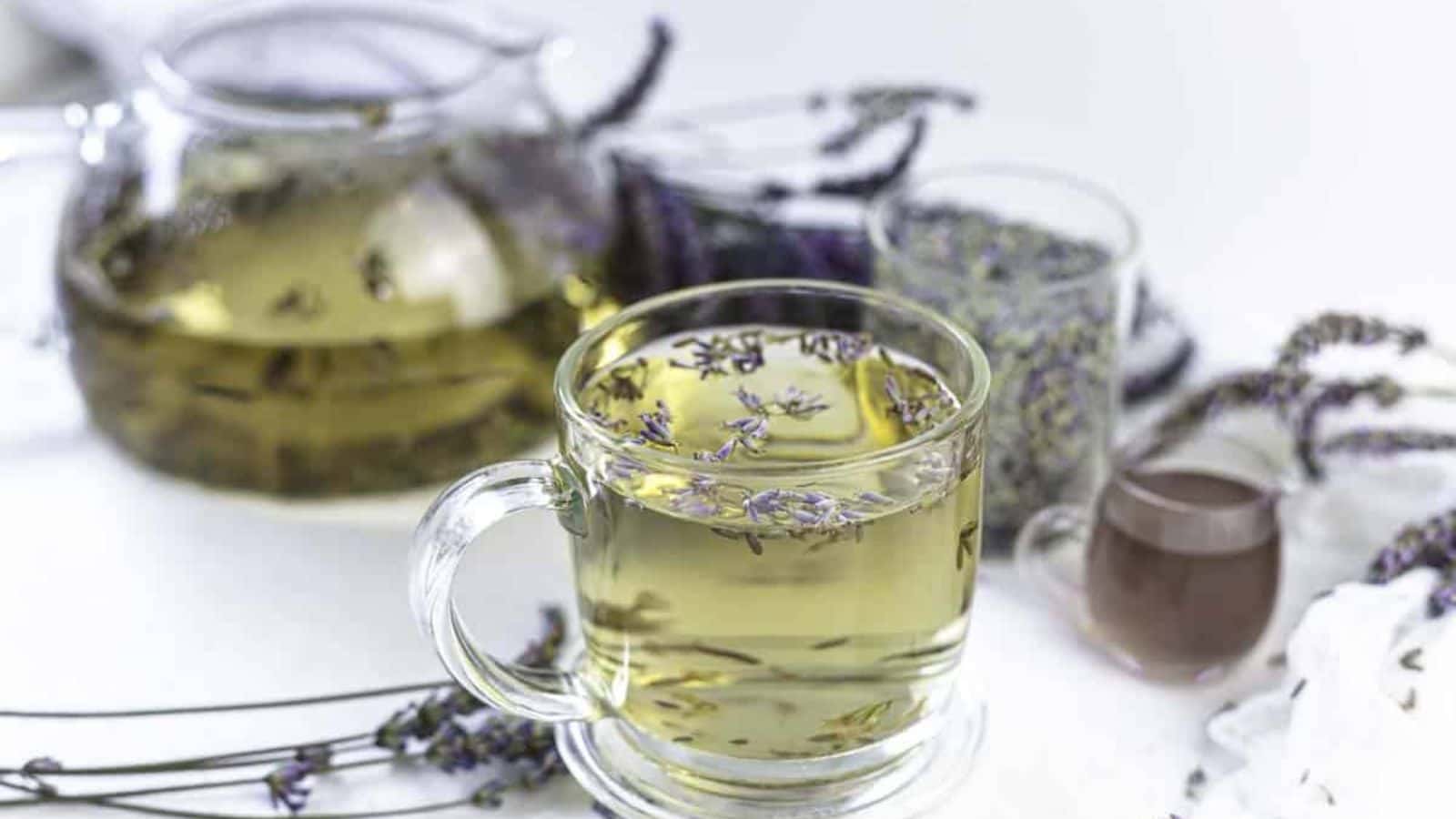 A clear glass cup filled with lavender tea.
