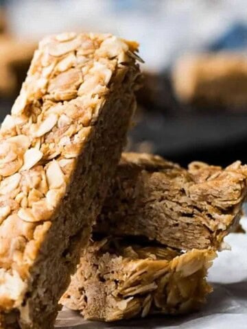 A stack of peanut butter oatmeal bars on a piece of paper.