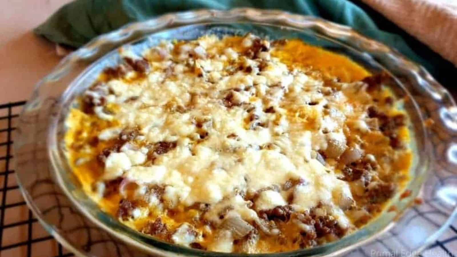 A picture of melted cheese over ground beef casserole.