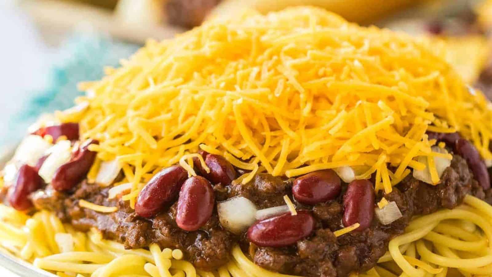 Cincinnatti chili on top of spaghetti and covered with cheese, beans and onions.