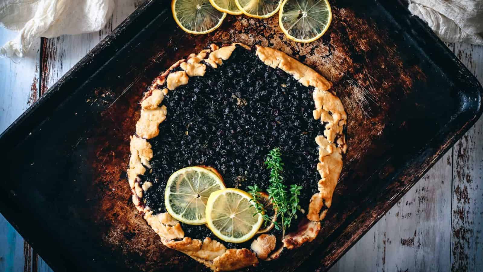 Blueberry galette with lemon slices on top.