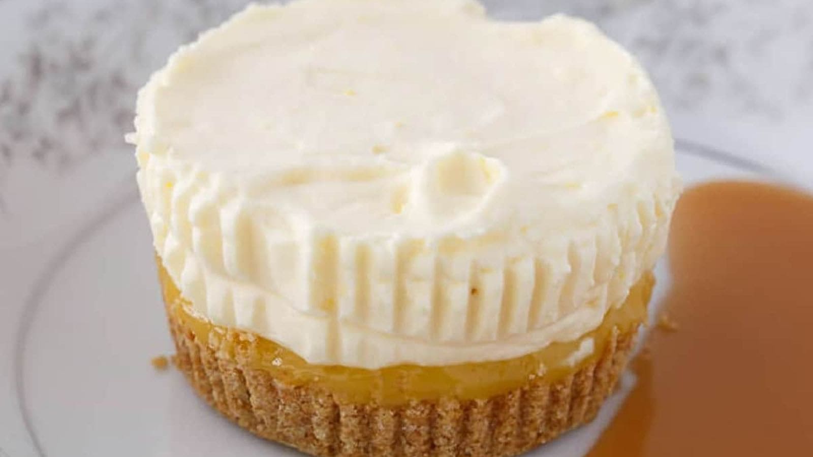 Pineapple Ice Cream Cake on a white plate next to a pool of sauce.