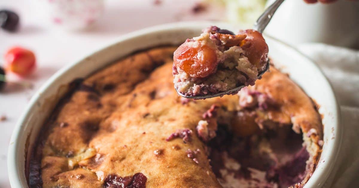 side view of slice of cherry cobbler with ice cream.