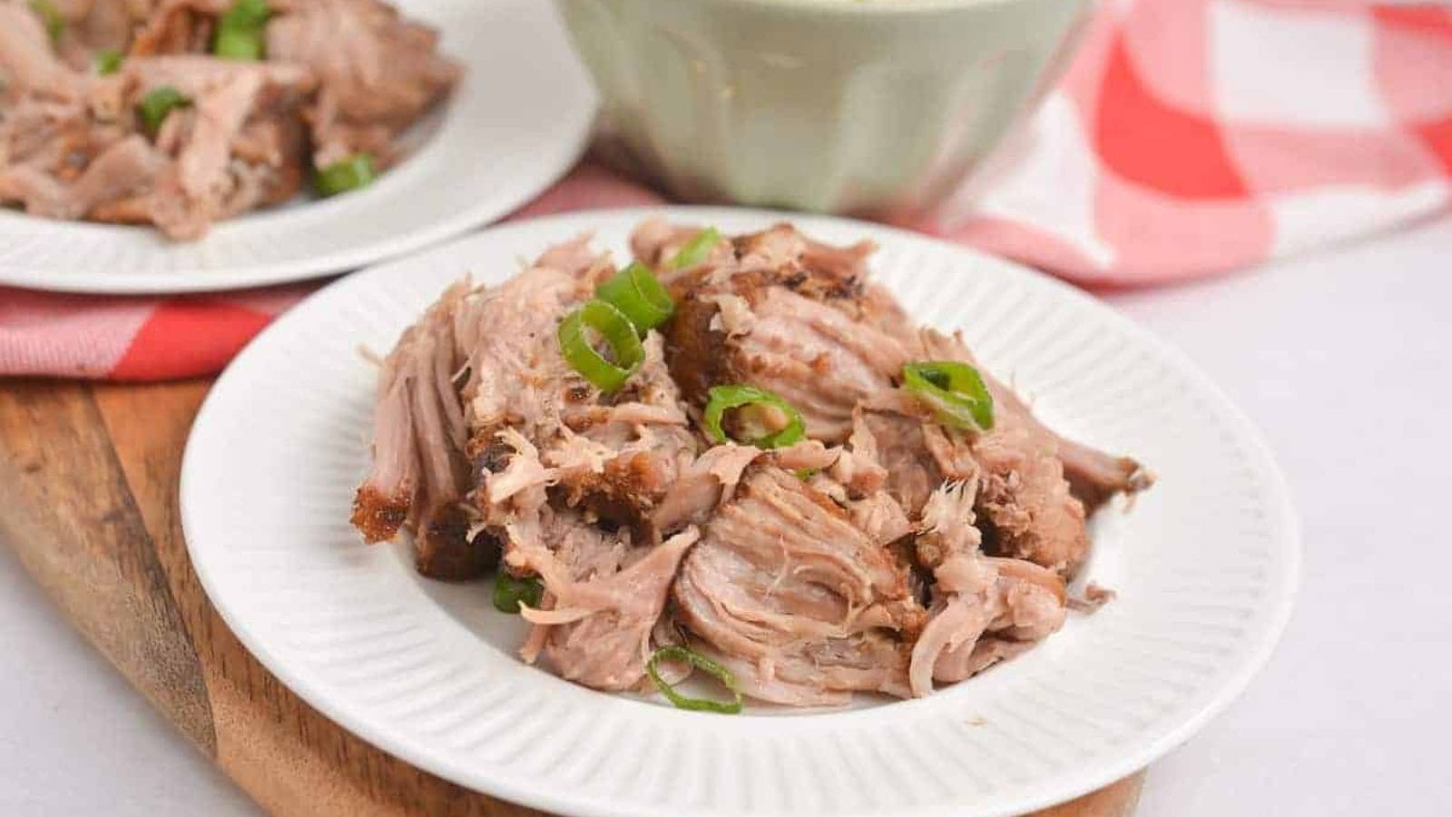 Shredded pork on a white plate.