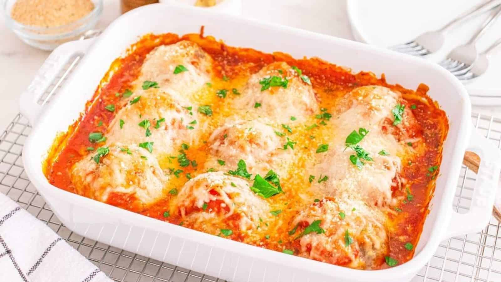 Meatball casserole on a white tray.
