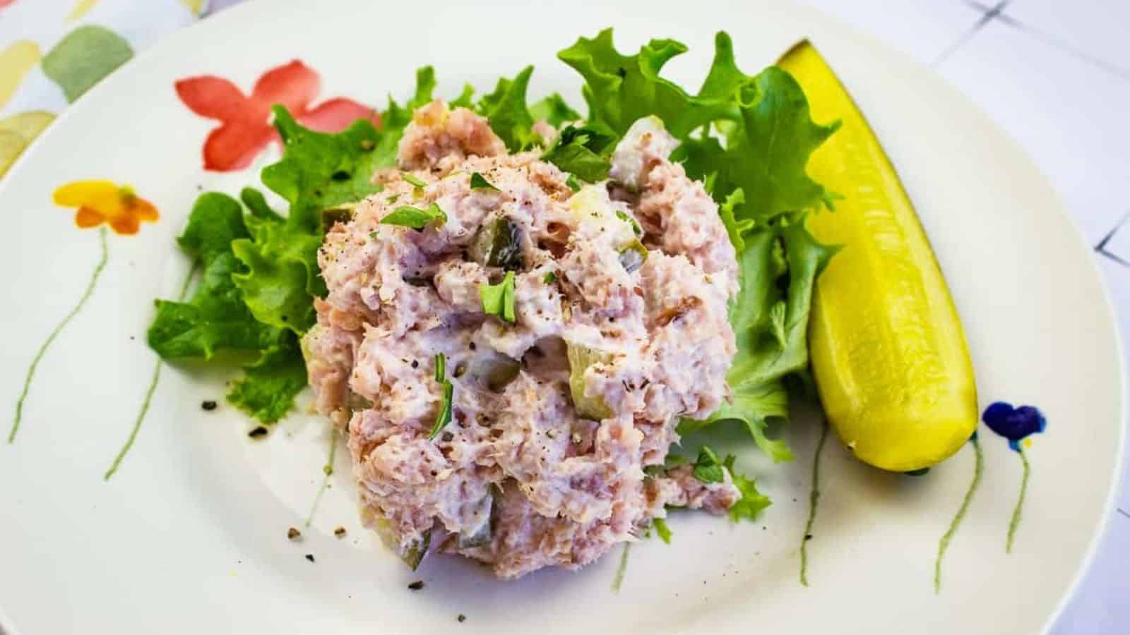 Ham Salad with dill pickle on a plate.