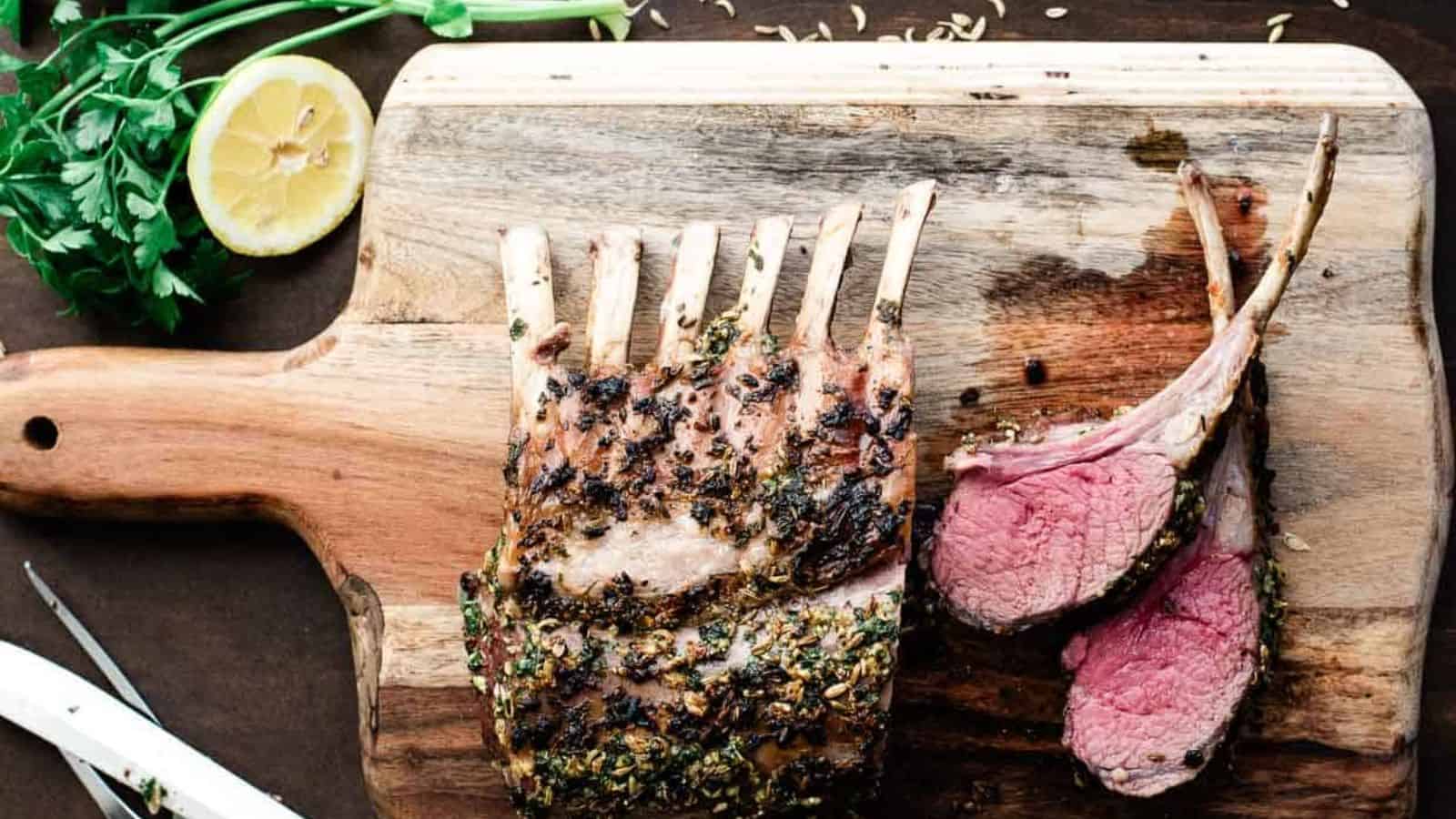 Roasted rack of lamb on a cutting board.