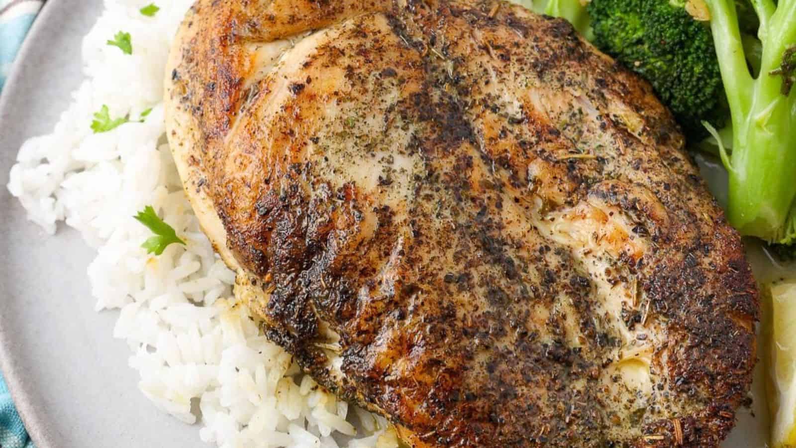 Grilled chicken with a flavorful marinade served on a plate.