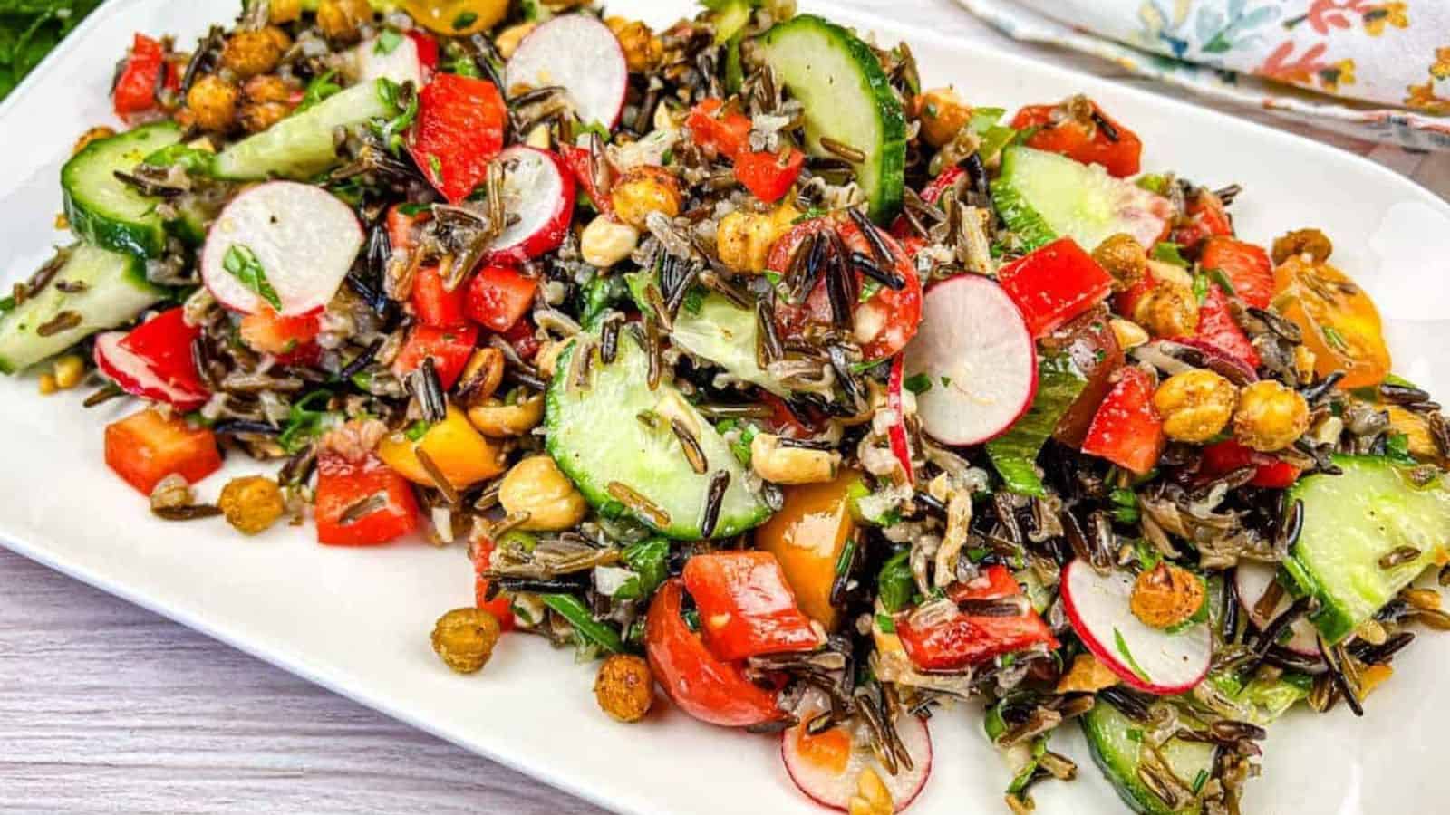 Wild rice salad served on a white rectangular plate.