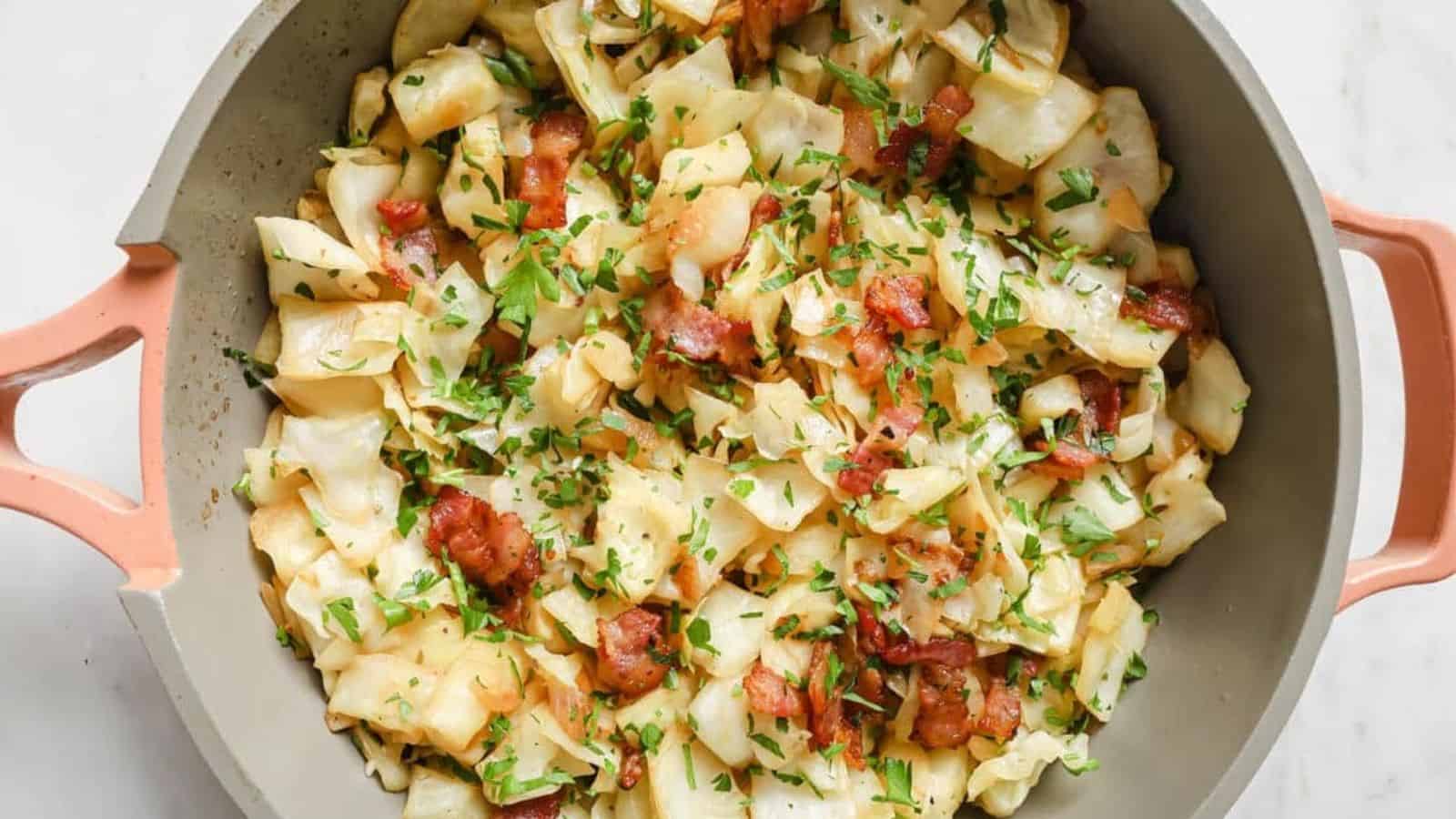 A pan full of bacon and cabbage with a wooden spoon.