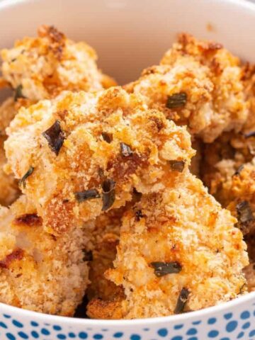 A bowl filled with crispy, golden-brown breaded chicken nuggets.