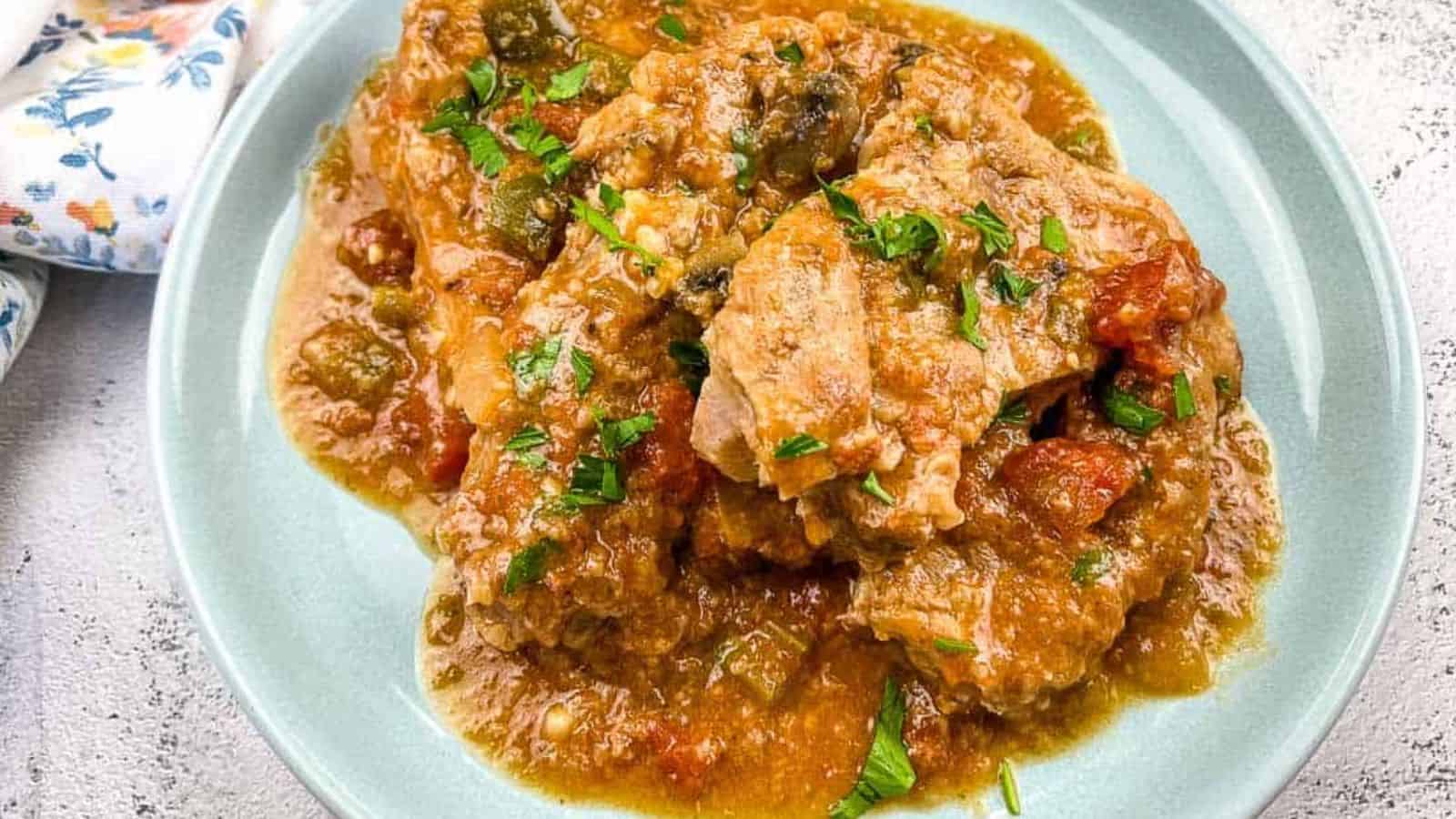 Slow Cooker Swiss Pork Chops on a baby blue serving dish.