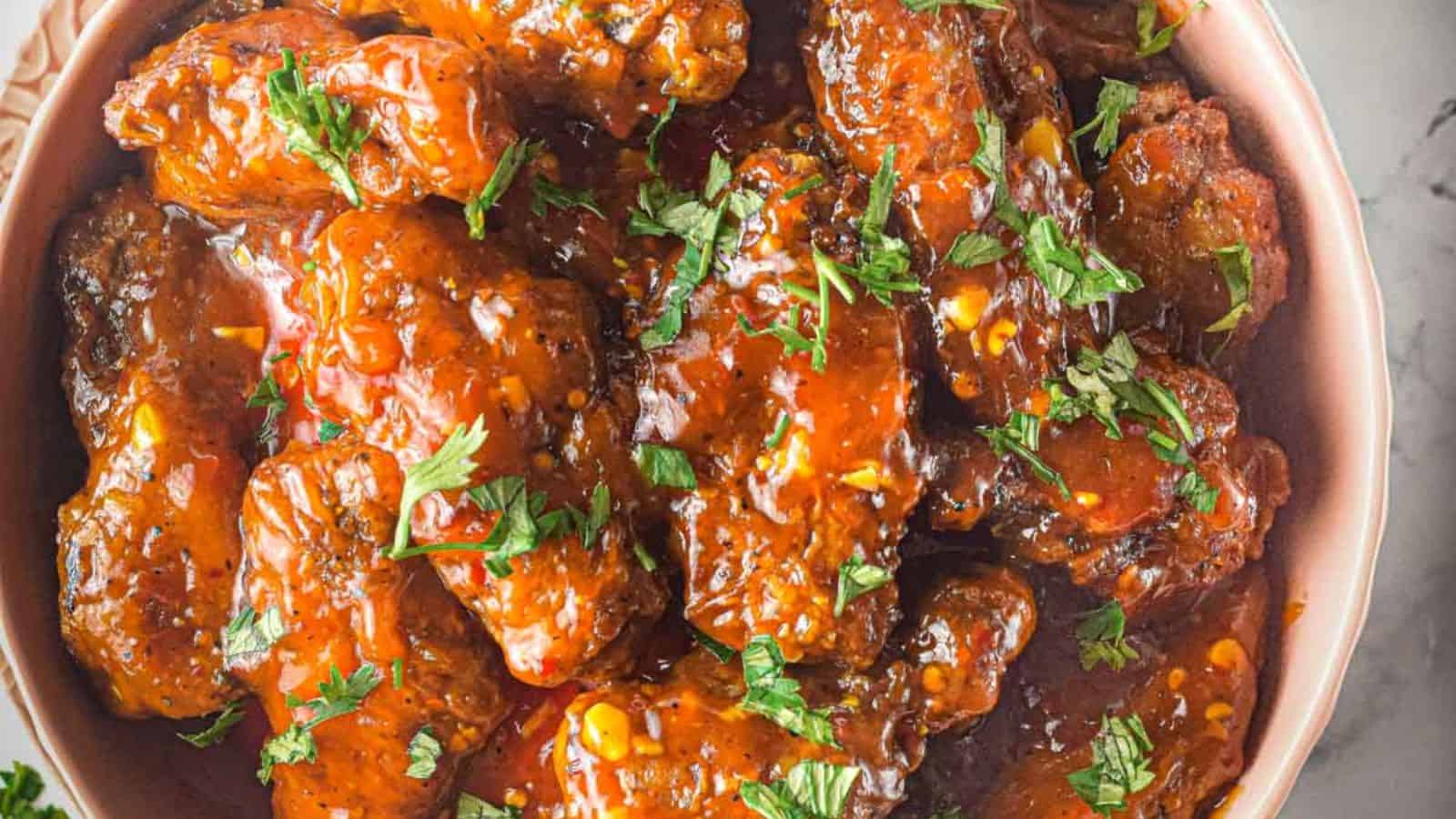 Bowl of Thai sweet chili wings on a gray and white napkin.