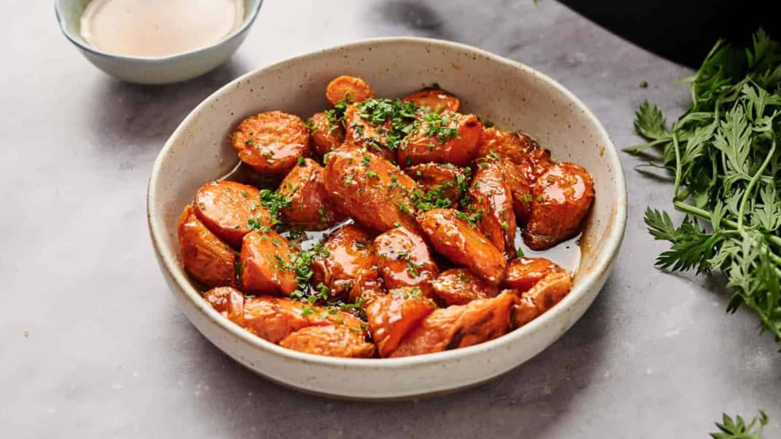 Air fryer glazed carrots in a bowl with parsley.