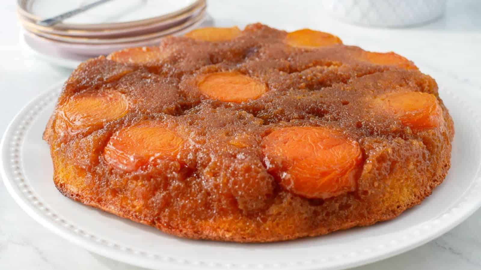A Apricot Upside Down Cake on a white plate.