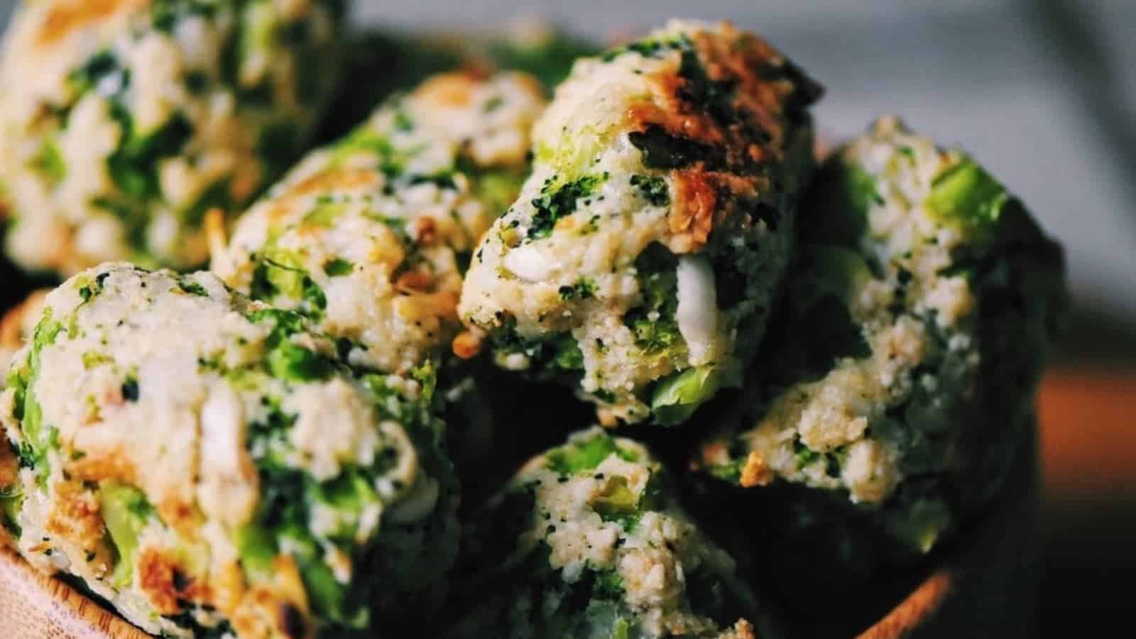 Close-up of broccoli and cheese tots, golden-brown and crispy, stacked together in a bowl.