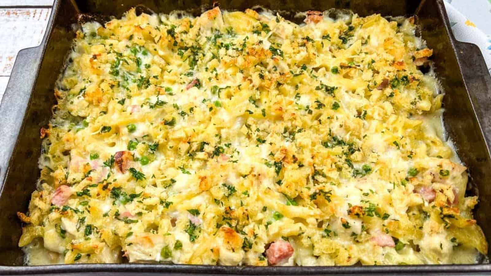 Chicken cordon bleu casserole on a black plate with a fork.