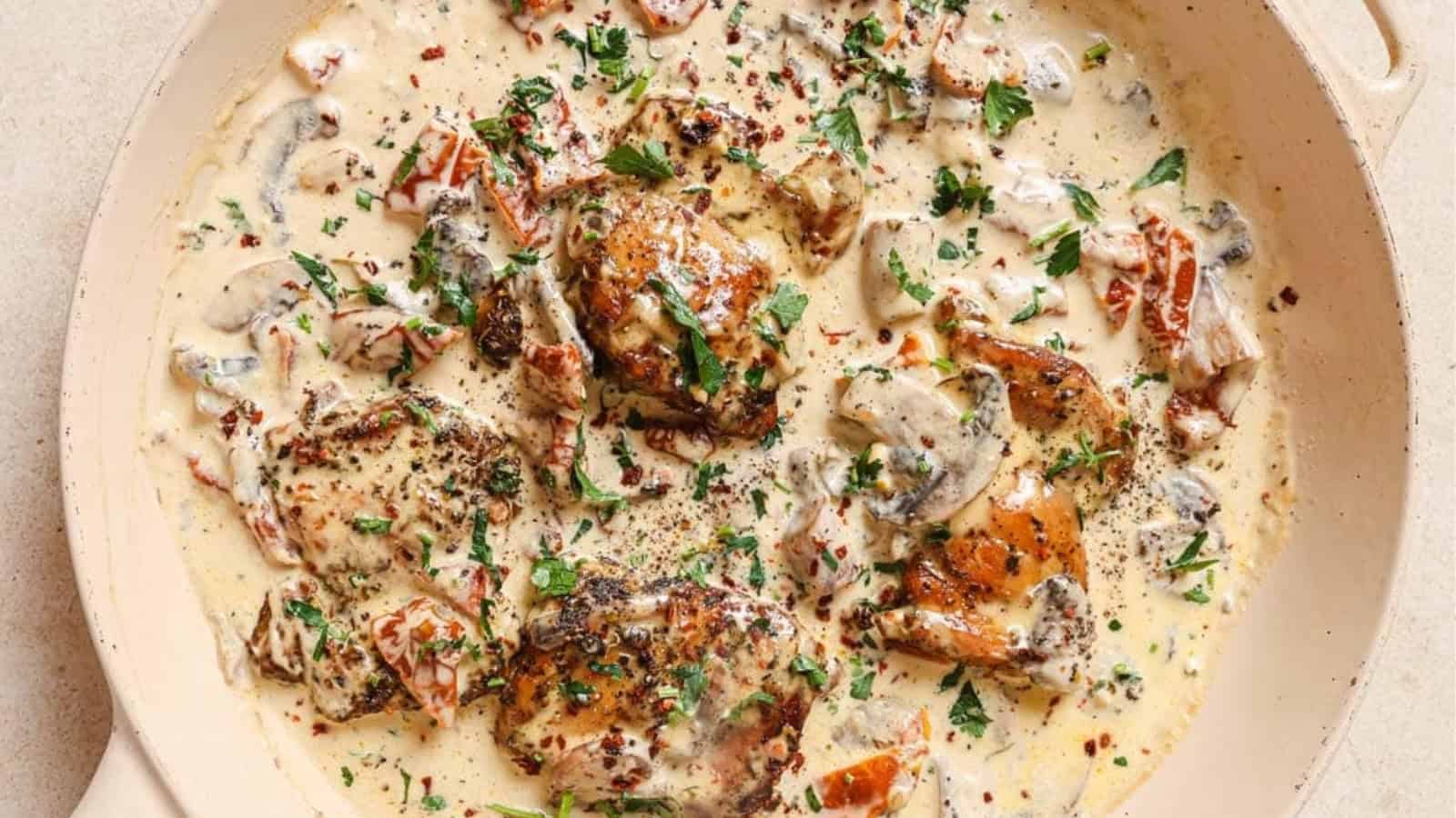 Chicken with creamy mushroom sauce in a pan.
