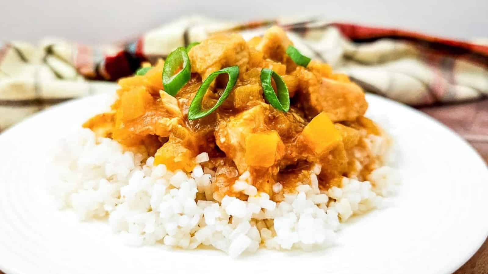 A plate of white rice topped with Crock Pot Hawaiian Chicken stew.