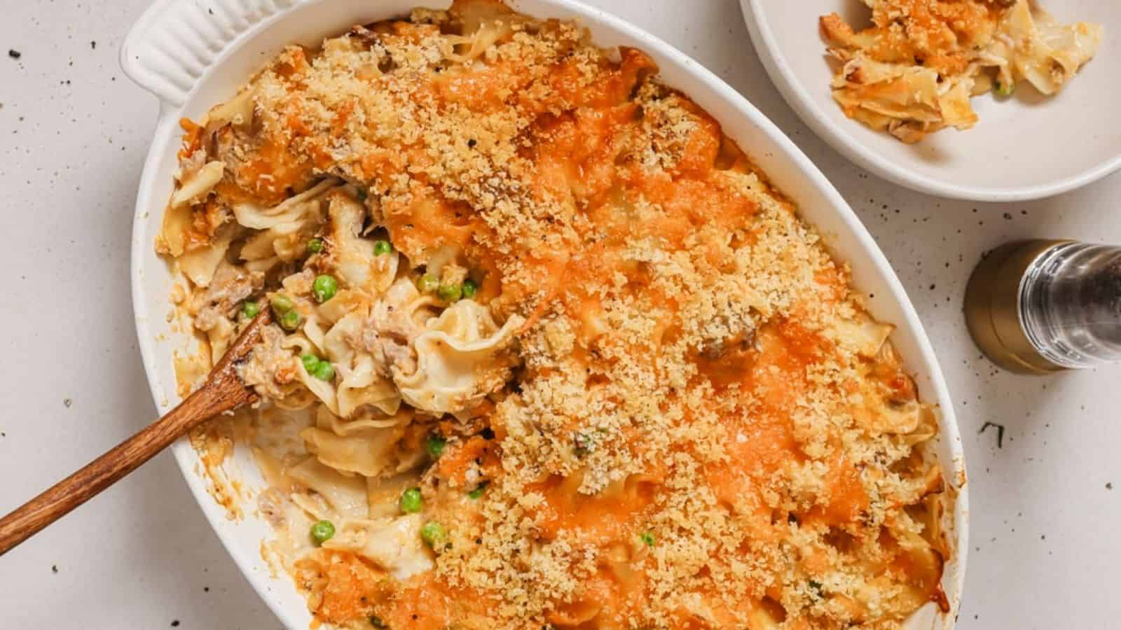 A casserole dish filled with pasta and peas.