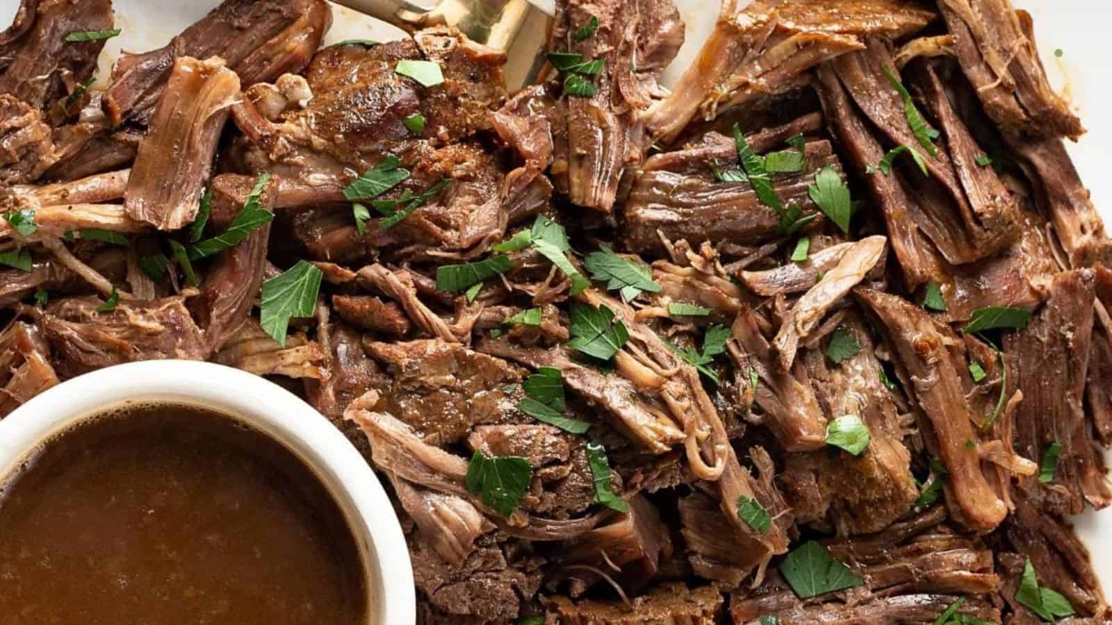 A bowl of instant pot roast beef with gravy and vegetables.
