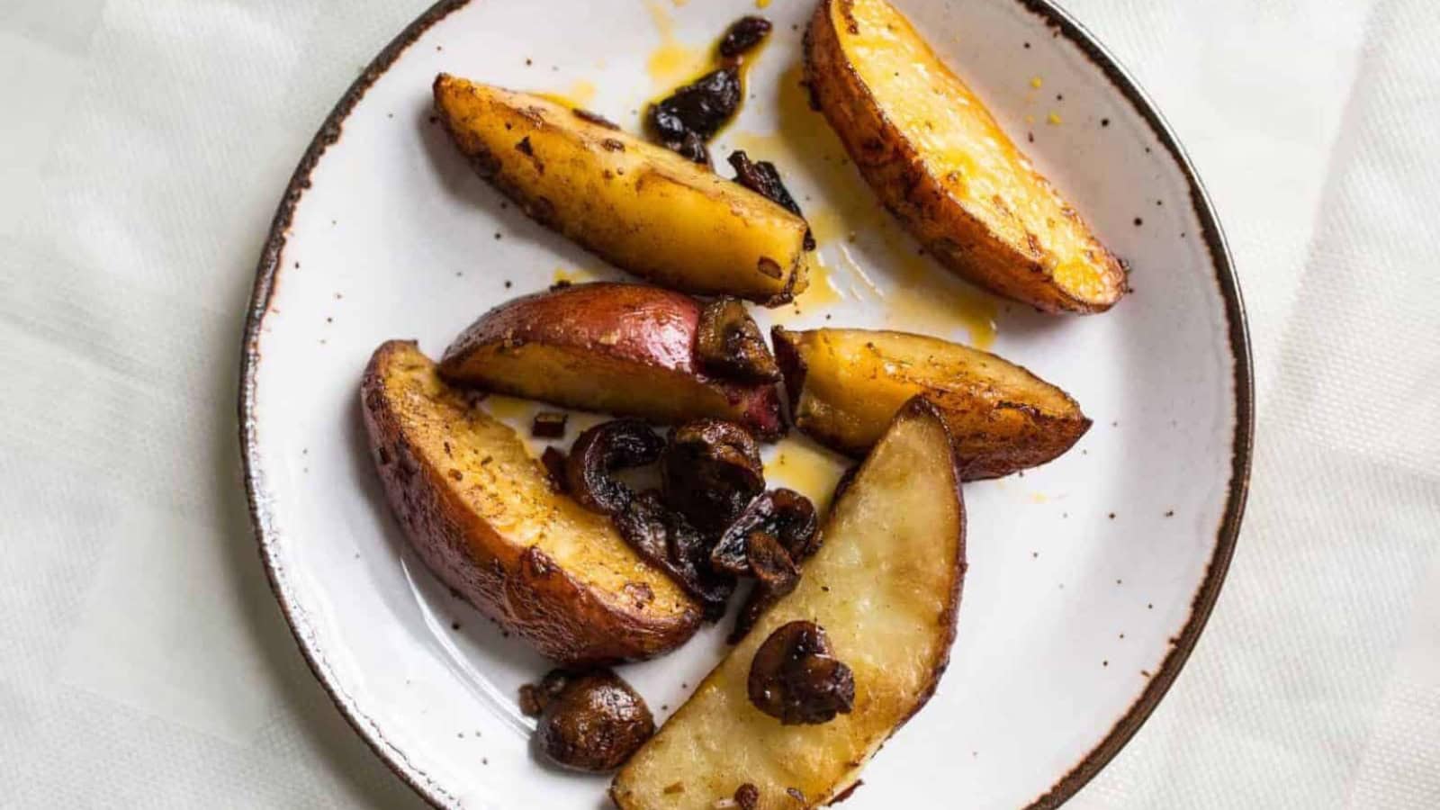 Overhead view of plate of potatoes and mushrooms.