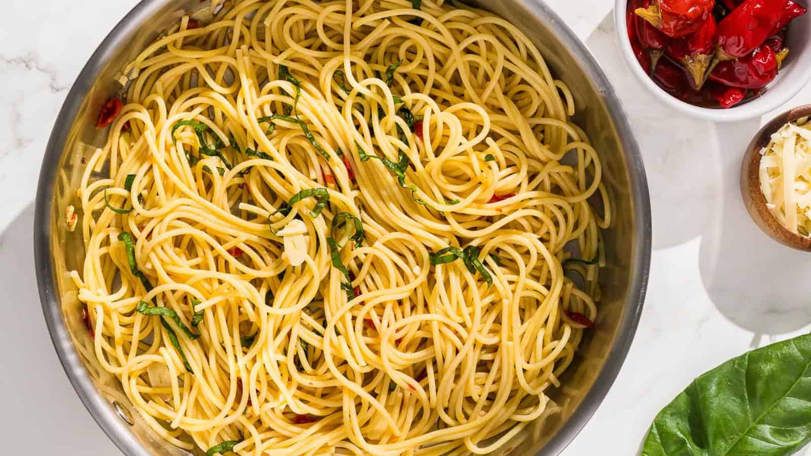 pasta aglio olio e peperoncino is mixed with a black pasta fork.