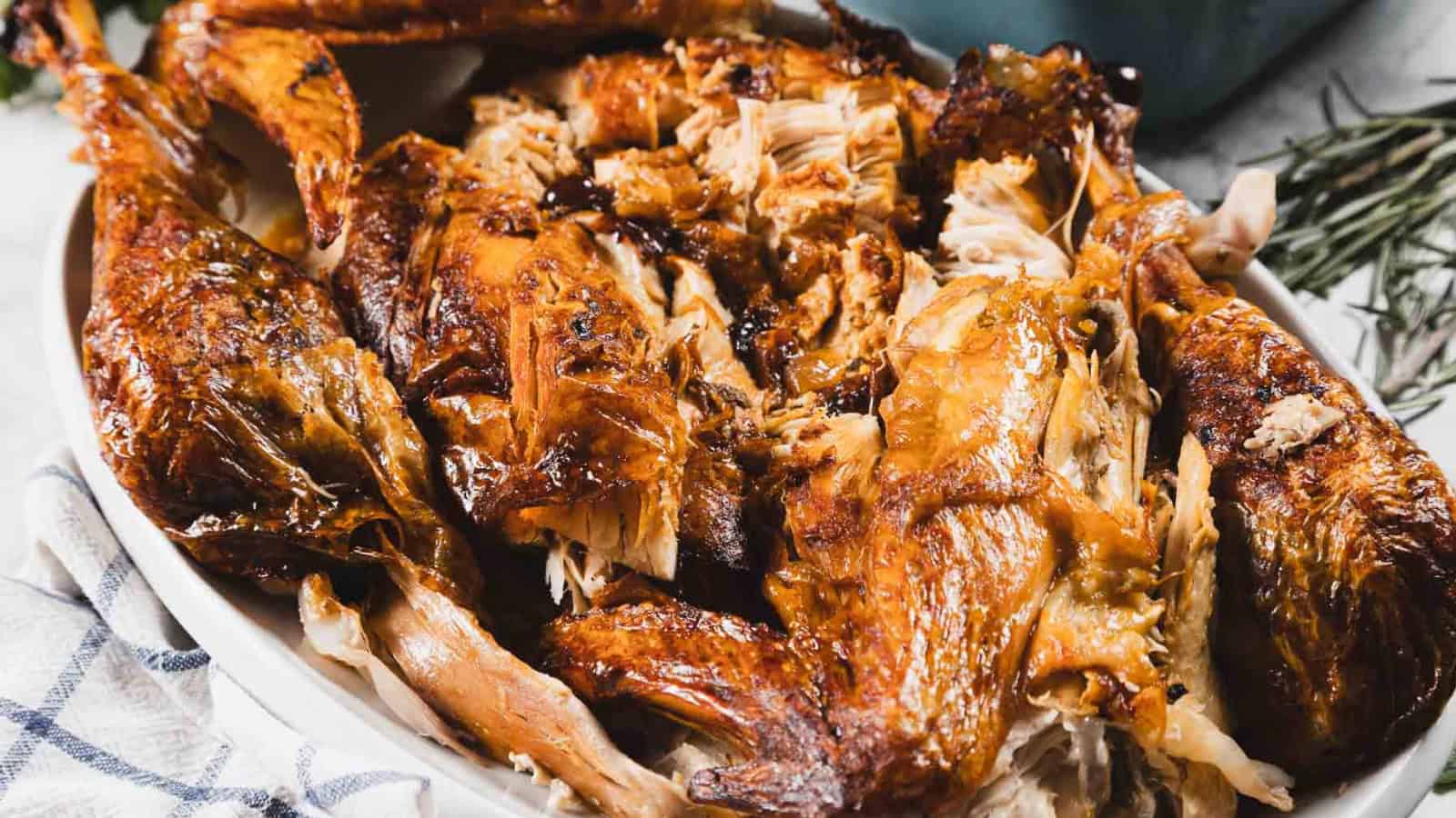 A platter filled with pieces of roasted turkey, showing crispy golden-brown skin and juicy meat.