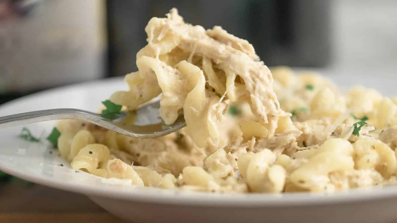 Olive garden chicken pasta on a fork.