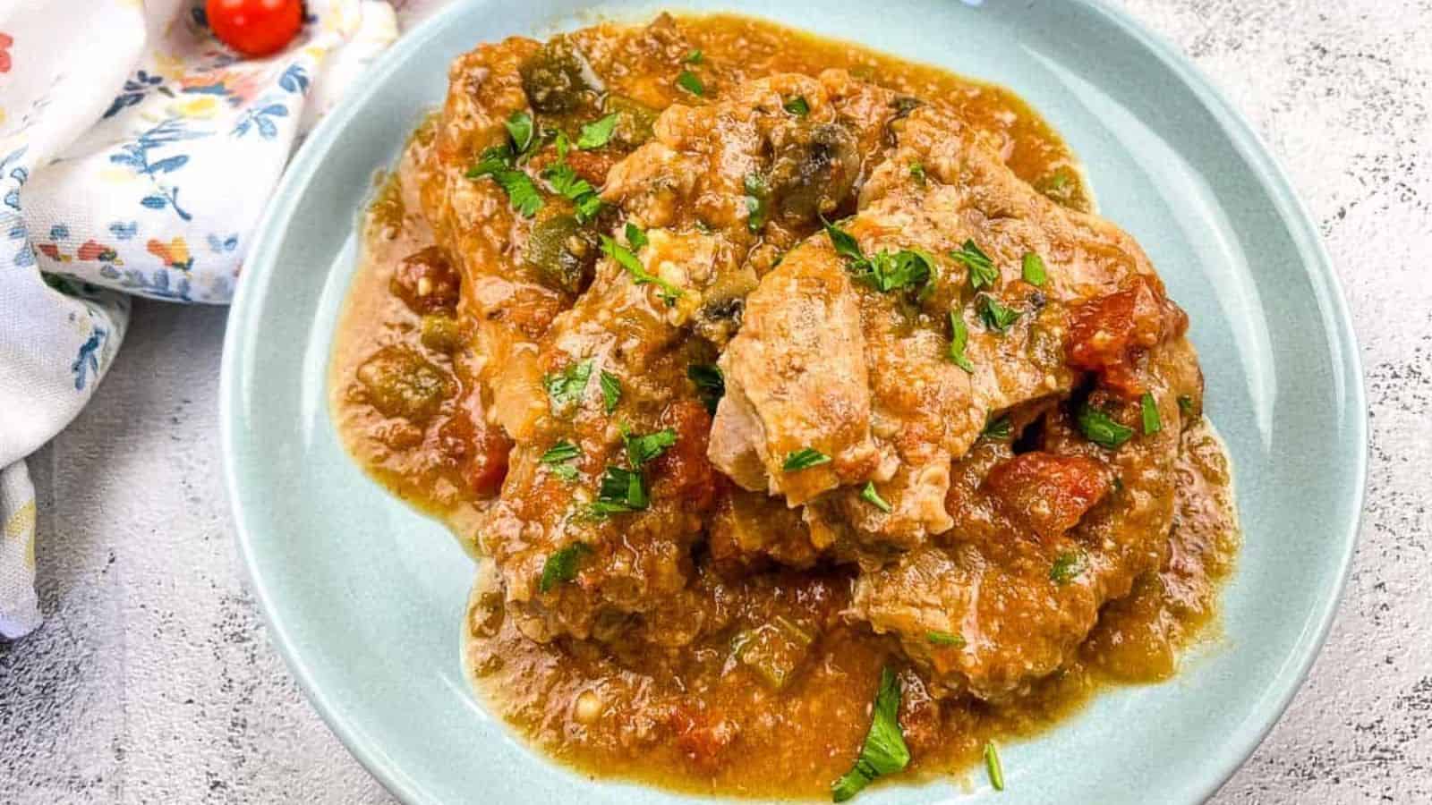 Slow Cooker Swiss Pork Chops on a baby blue serving dish.
