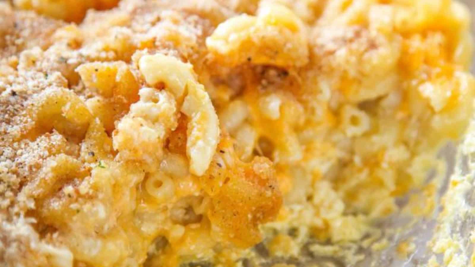 Baked macaroni and cheese topped with breakcrumbs in a casserole dish.