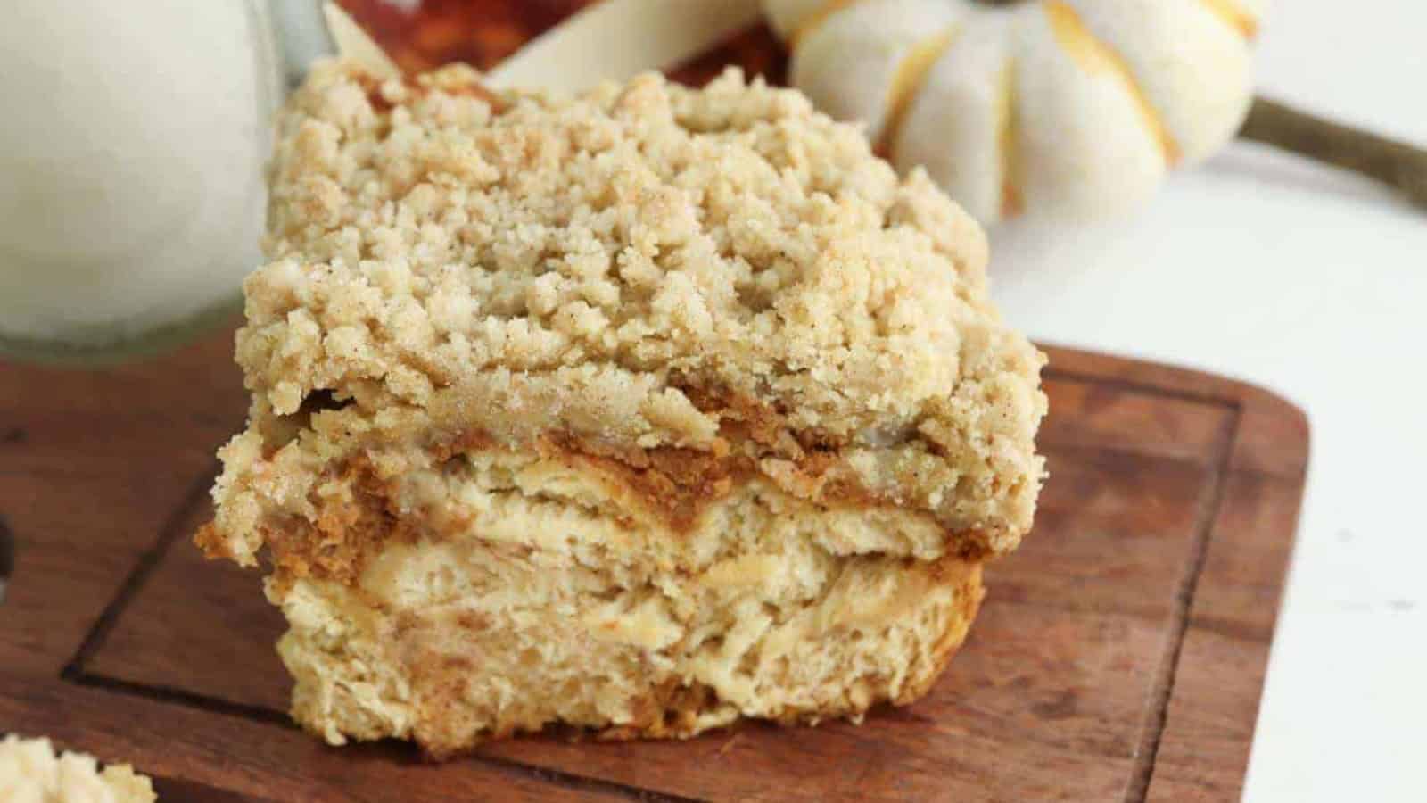A piece of pumpkin crumb cake on a cutting board.