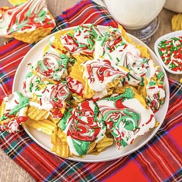 Wavy chips topped with white chocolate, red and green swirls, and sprinkles on a plaid cloth&mdash;this festive Potato Chip Christmas Crack is the perfect sweet-and-salty treat for your holiday spread.