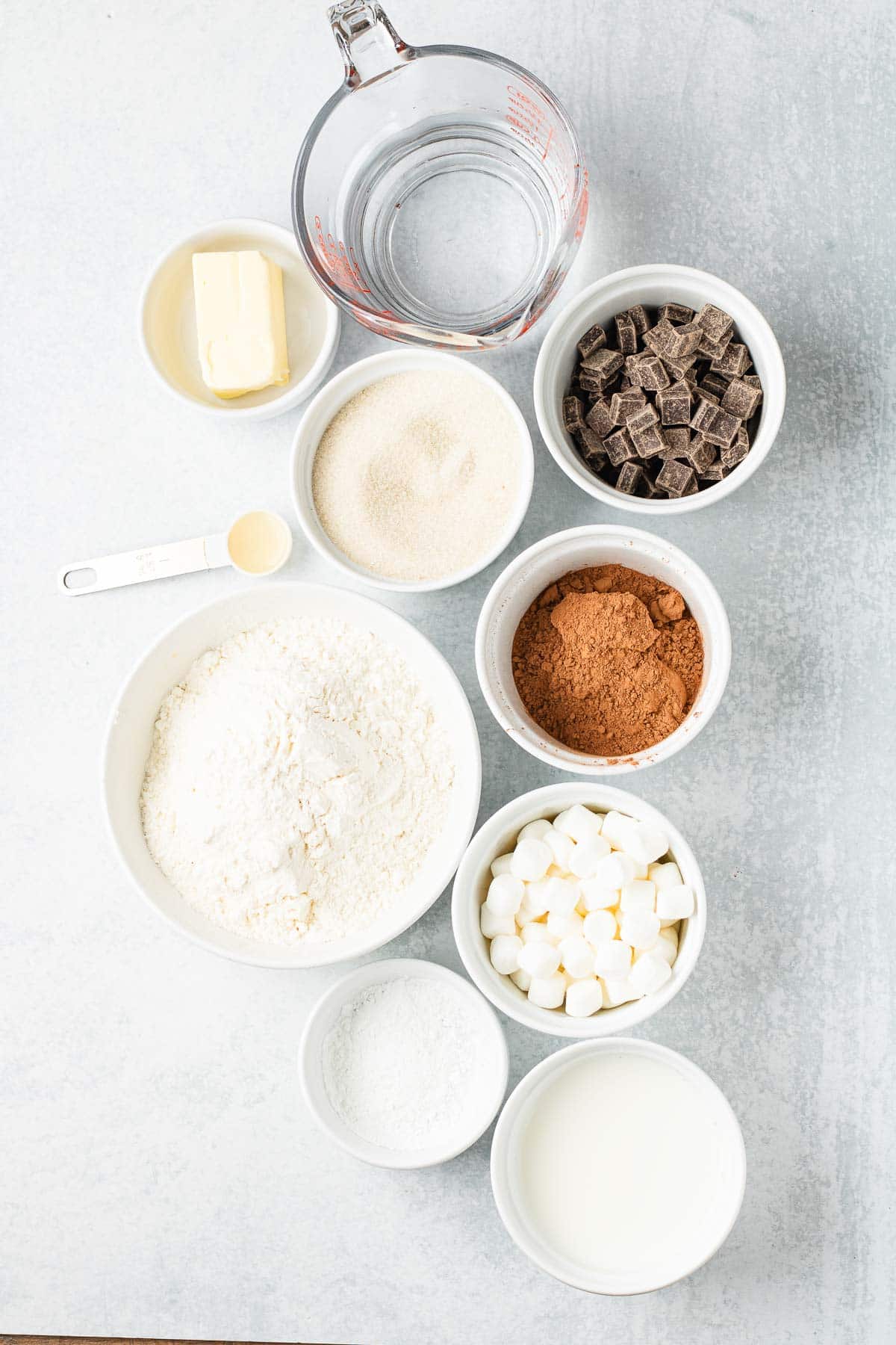 Bowls of flour, sugar, cocoa, chocolate chunks, marshmallows, butter, milk, and a measuring cup of water&mdash;everything you need to create a decadent Hot Chocolate Dessert or try your favorite Hot Chocolate Cobbler recipe.