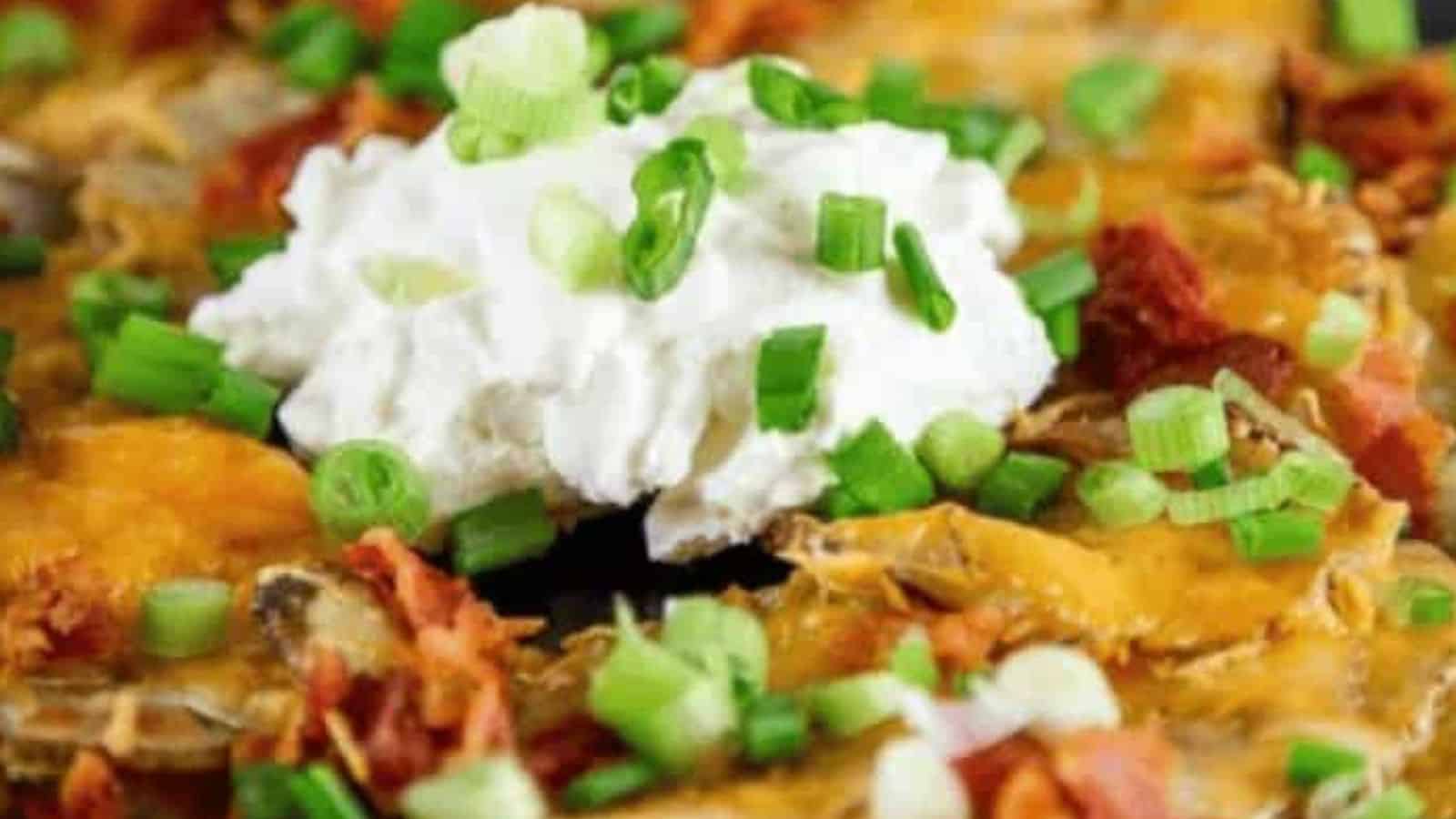 Potato rounds topped with cheese, bacon, sour cream, and green onions.